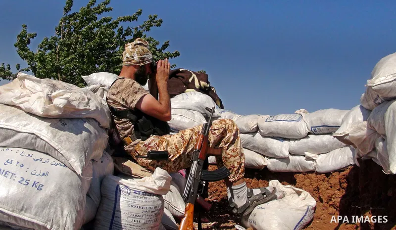 A fighter from the Free Syrian Army's Al-Tawhid Brigade takes a position at the border with Dabiq city, the stronghold of the ISIS fighters, in the Mare' city in the north of Aleppo, on June 30, 2015. Photo by Ameer al-H...