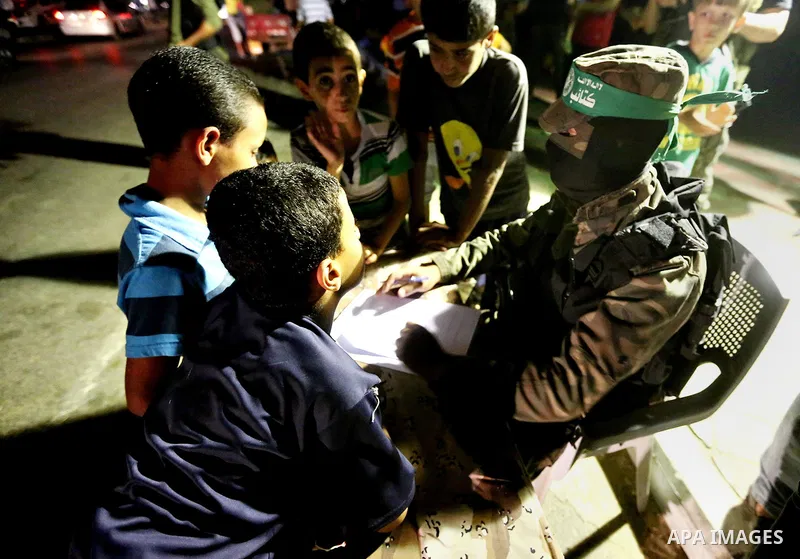 Palestinians boys wait to register their names in the summer camps organized by the Izzedine al-Qassam brigades, loyal to Hamas movement, in Gaza city on June 29, 2015. Photo by Nidal Alwaheidi