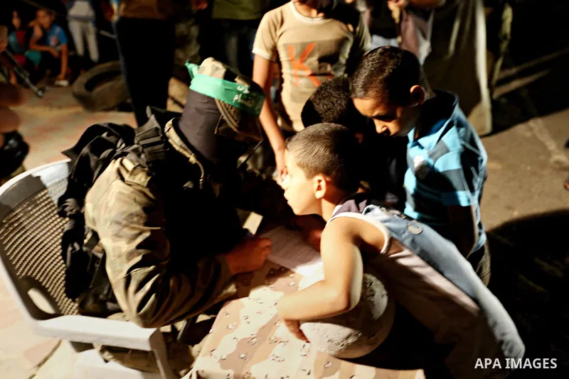 Palestinians boys wait to register their names in the summer camps organized by the Izzedine al-Qassam brigades, loyal to Hamas movement, in Gaza city on June 29, 2015. Photo by Nidal Alwaheidi
