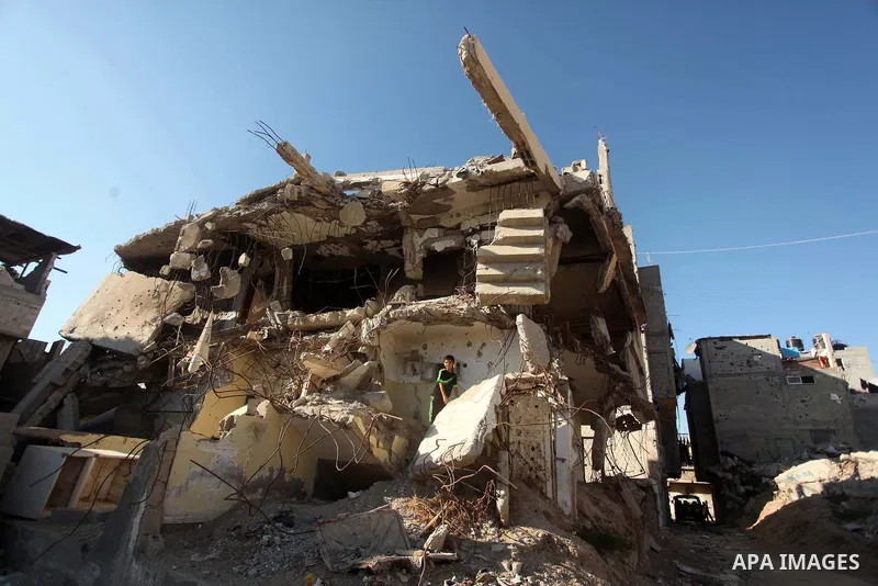 A Palestinian boy plays on the ruins of houses, that witnesses said were destroyed by Israeli shelling during a 50-day war last summer, in the east of Gaza City July 8, 2015. The majority of children living in areas of G...