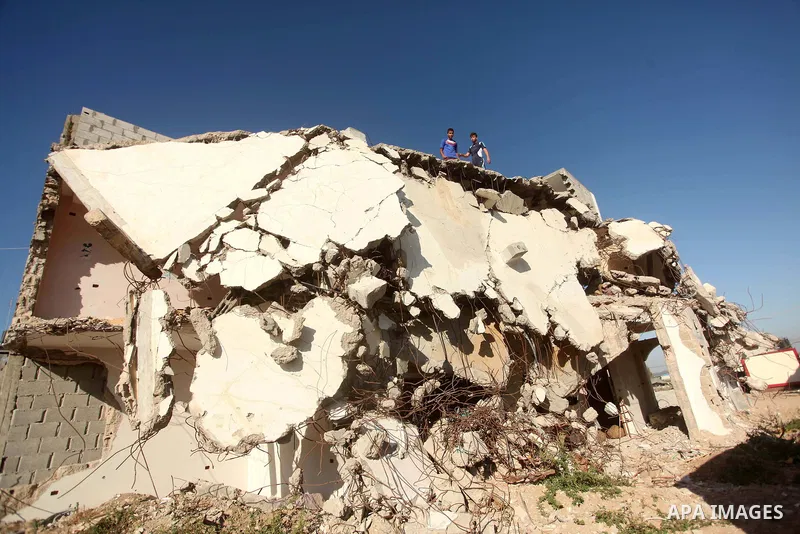 Palestinian children play on the ruins of houses, that witnesses said were destroyed by Israeli shelling during a 50-day war last summer, in the east of Gaza City July 8, 2015. The majority of children living in areas of...
