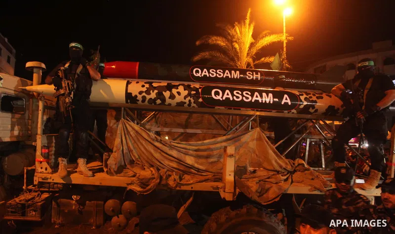 Palestinian Hamas militants hold their weapons during a march marking the first anniversary of the 50-day Israeli war on Gaza Strip last summer, in Gaza City July 8, 2015. July 8th marks the one-year anniversary of the w...