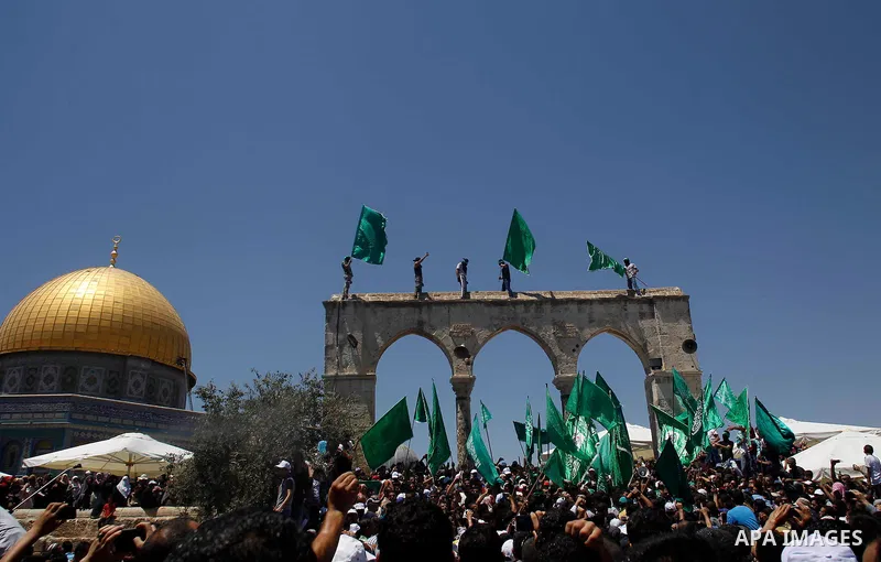 Palestinians wave Hamas movement flags during a demonstration to mark the Quds (Jerusalem) day following Friday prayer outside the Dome of the Rock mosque at the al-Aqsa mosque compound, Islam s third holiest site, in Je...