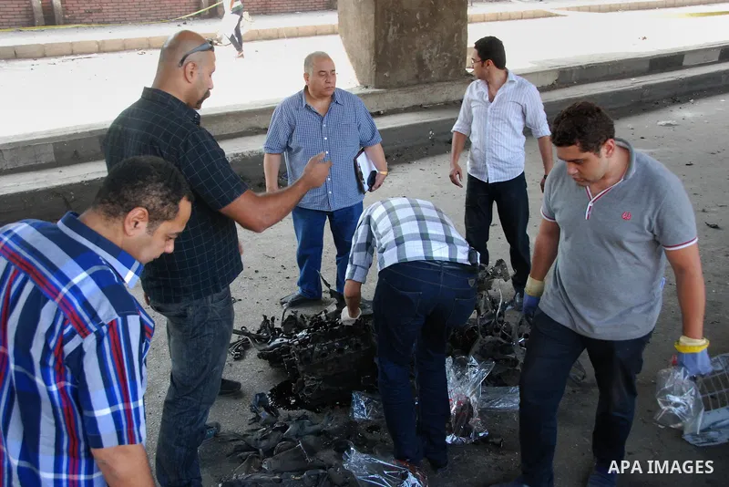 Egyptian security officials inspect the site of a bomb blast at the Italian Consulate in Cairo, Egypt, July 11, 2015. A bomb exploded in front of the Italian consulate in Cairo on Saturday, killing one person, the health...
