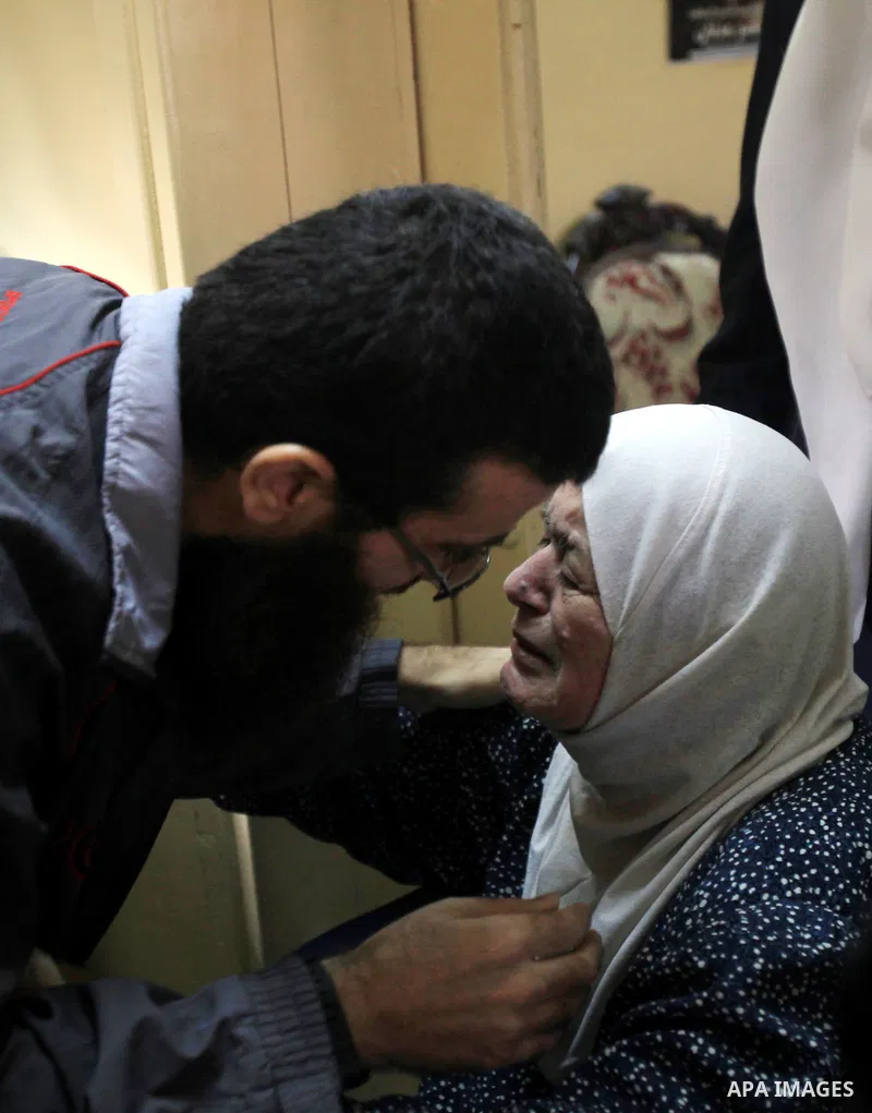 Khader Adnan, a Palestinian prisoner who staged a 56-day hunger strike while being detained for a year without charge by Israeli authorities, is greeted by his mother as he arrives in the West Bank village of Arraba afte...