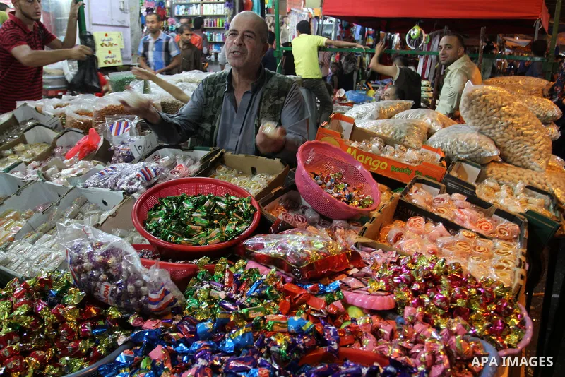 Palestinians shop in a market ahead of the Eid al-Fitr holiday marking the end of Ramadan, in Rafah in the southern Gaza Strip on July 16, 2015. Muslims the world over prepare to celebrate Eid al-Fitr, starting wth the s...