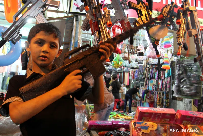 Palestinians shop in a market ahead of the Eid al-Fitr holiday marking the end of Ramadan, in Rafah in the southern Gaza Strip on July 16, 2015. Muslims the world over prepare to celebrate Eid al-Fitr, starting wth the s...