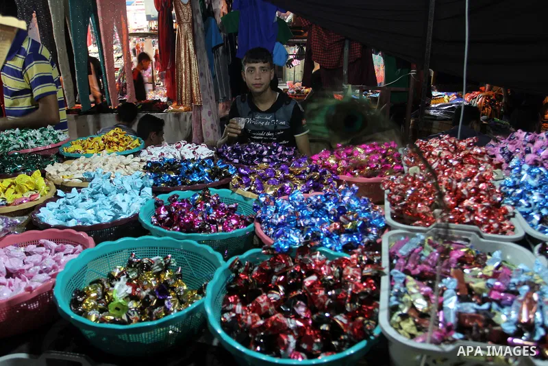 Palestinians shop in a market ahead of the Eid al-Fitr holiday marking the end of Ramadan, in Rafah in the southern Gaza Strip on July 16, 2015. Muslims the world over prepare to celebrate Eid al-Fitr, starting wth the s...