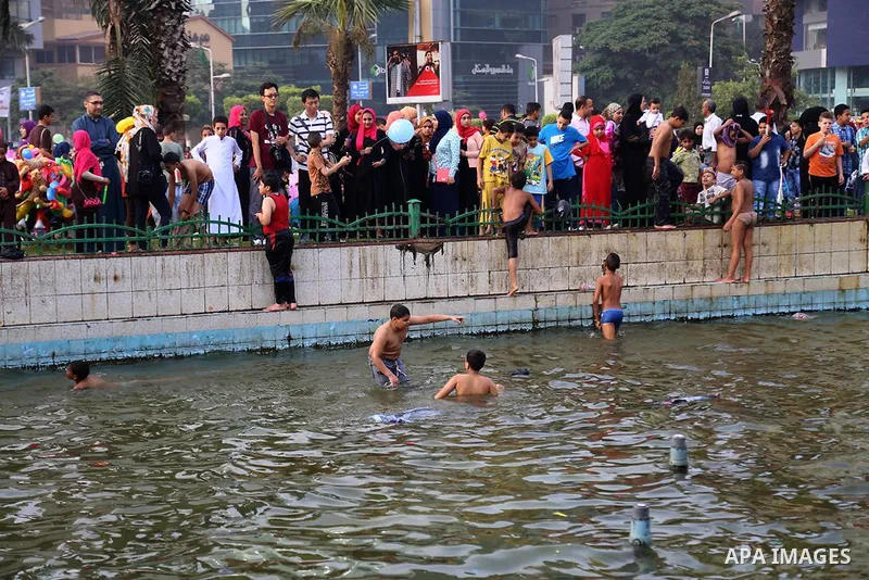 Egyptians swim as they celebrate Eid al-Fitr at Mustafa Mahmoud pond, in Cairo, Egypt, on July 17, 2015. Eid al-Fitr marks the end of the Muslim holy month of Ramadan. Photo by Amr Sayed