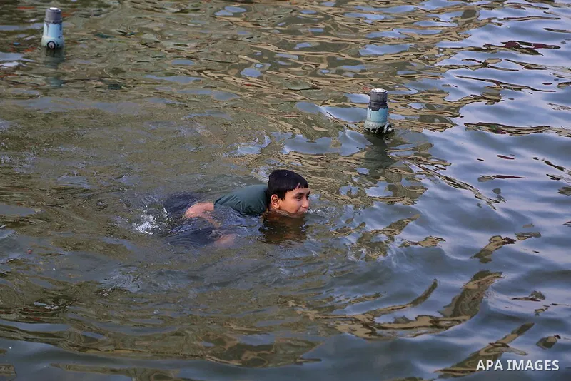 Egyptians swim as they celebrate Eid al-Fitr at Mustafa Mahmoud pond, in Cairo, Egypt, on July 17, 2015. Eid al-Fitr marks the end of the Muslim holy month of Ramadan. Photo by Amr Sayed