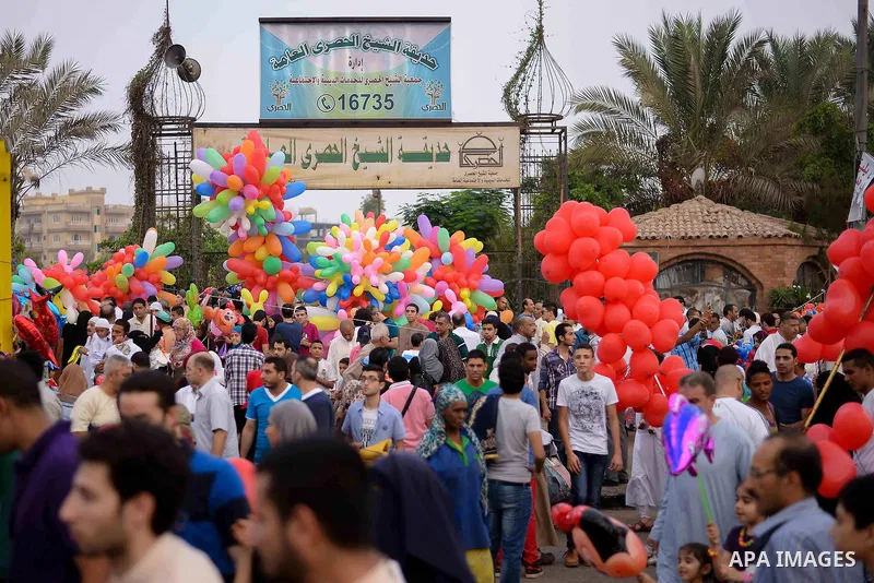 Egyptians celebrate Eid al-Fitr in Cairo, Egypt, on July 17, 2015. Eid al-Fitr marks the end of the Muslim holy month of Ramadan. Photo by Amr Sayed