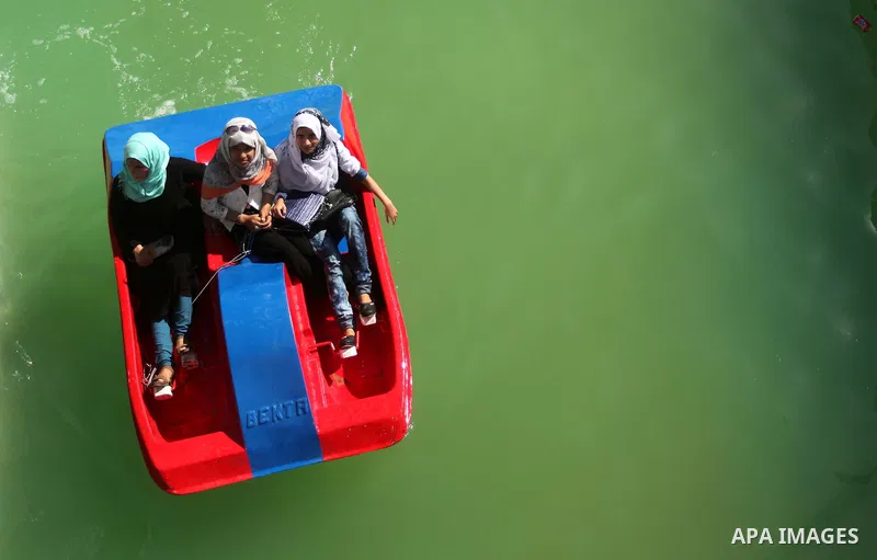 Palestinians enjoy riding in a pool at an amusement park on the third day of Eid al-Fitr holiday which marks the end of the Muslim holy month of Ramadan, in Gaza City on July 19, 2015. Photo by Ashraf Amra