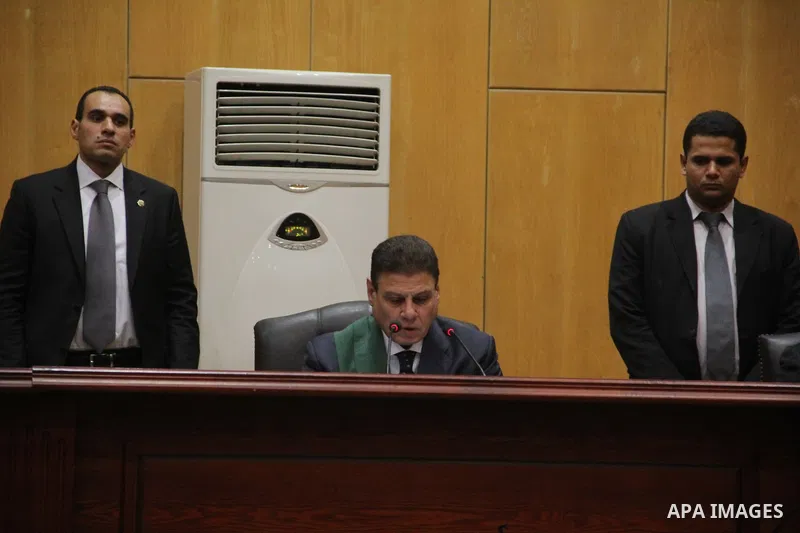 Egyptian Judge Mohammed Sheren Fahmi (R) attends the trial of member sof Egyptian Muslim Brotherhood at the police academy on the outskirts of the capital, on July 21, 2015. Cairo criminal court resumed proceedings in th...