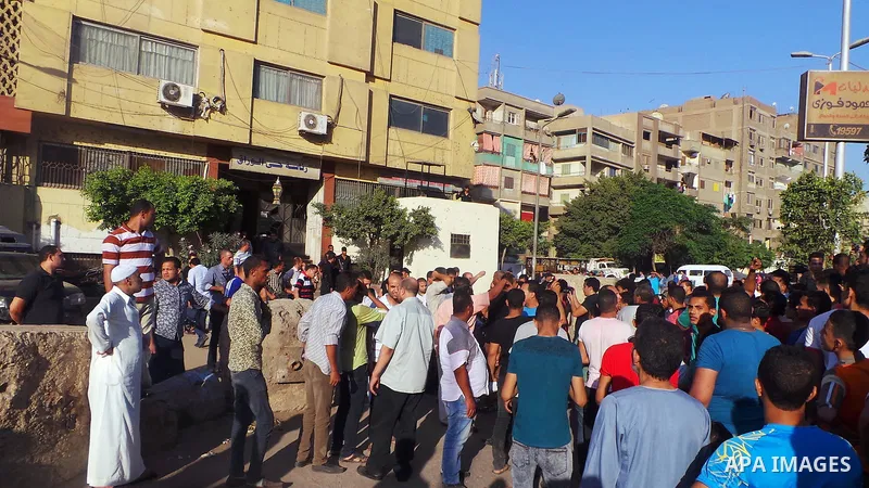 People, including relatives, shout slogans against government during a search for victims of a boat collision on the River Nile in the Warraq area of Giza, south of Cairo, Egypt, July 23, 2015. At least 15 people drowned...