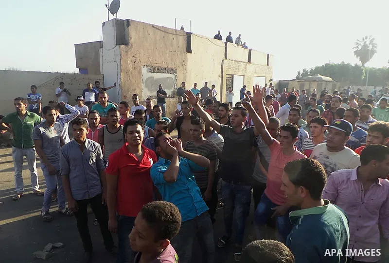 People, including relatives, shout slogans against government during a search for victims of a boat collision on the River Nile in the Warraq area of Giza, south of Cairo, Egypt, July 23, 2015. At least 15 people drowned...