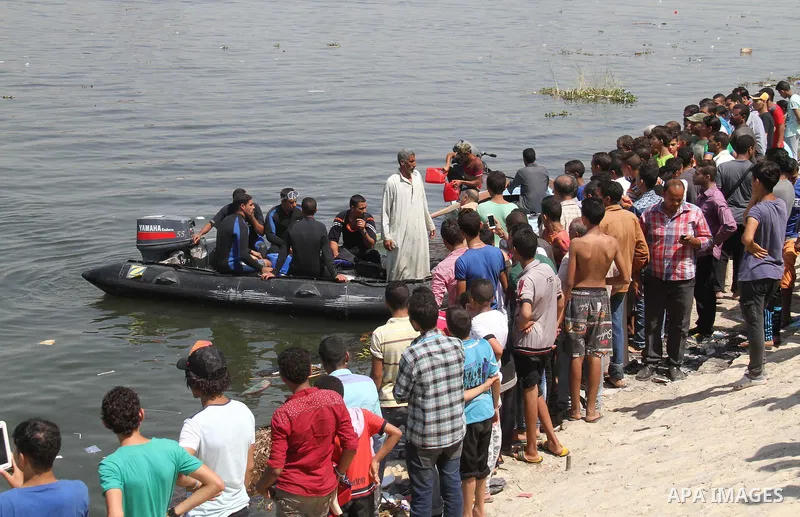 People, including relatives, shout slogans against government during a search for victims of a boat collision on the River Nile in the Warraq area of Giza, south of Cairo, Egypt, July 23, 2015. At least 15 people drowned...