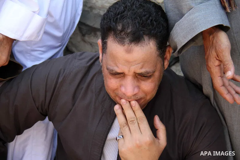 People, including relatives, react along during a search for the victims of a boat collision on the River Nile in the Warraq area of Giza, south of Cairo, Egypt, July 23, 2015. At least 15 people drowned when the small b...