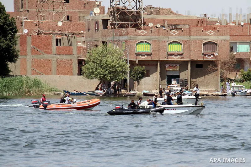 People, including relatives, shout slogans against government during a search for victims of a boat collision on the River Nile in the Warraq area of Giza, south of Cairo, Egypt, July 23, 2015. At least 15 people drowned...