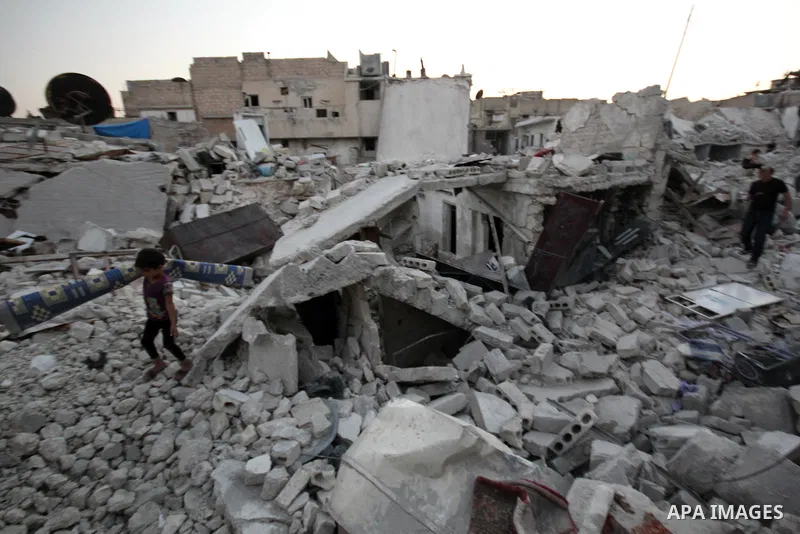 Syrians search in the rubble of buildings after a missile fired by Syrian government forces hit a residential area in the Maghayir district in the old quarter of the northern Syrian city of Aleppo on July 23, 2015. Accor...