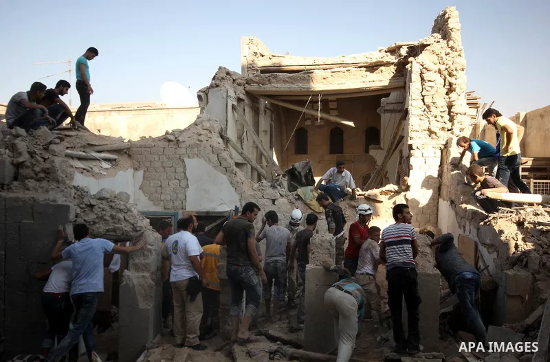 Syrians search for survivors amidst the rubble of a house after a reported missile fired by Syrian government forces hit a residential area in the Jeb Al-Qubbah district in the northern Syrian city of Aleppo on July 27,...