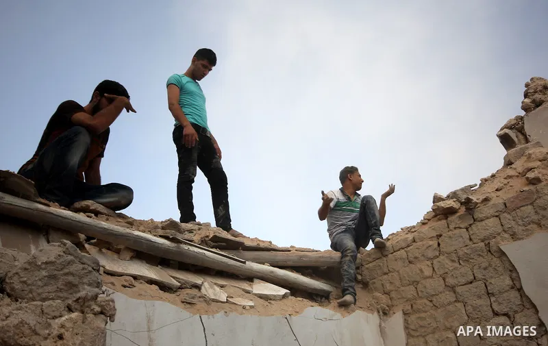 Syrians search for survivors amidst the rubble of a house after a reported missile fired by Syrian government forces hit a residential area in the Jeb Al-Qubbah district in the northern Syrian city of Aleppo on July 27,...