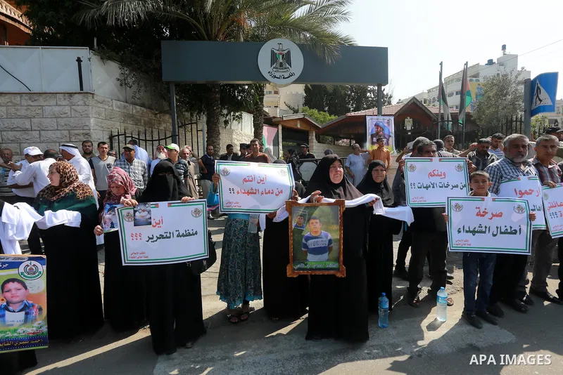 Palestinian families of martyrs take part a protest to demand their rights, in front of the headquarters of the Council of Ministers in Gaza city, on July 28, 2015. Photo by Mohammed Asad