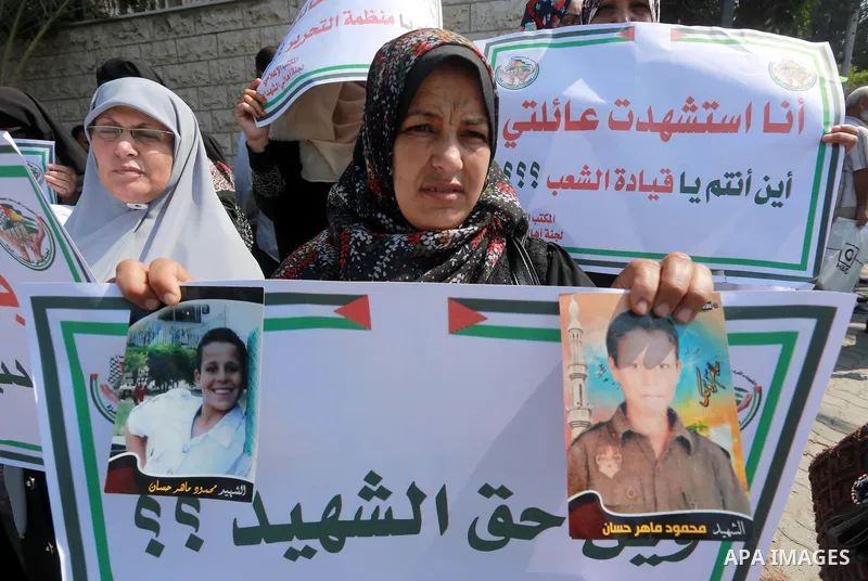 Palestinian families of martyrs take part a protest to demand their rights, in front of the headquarters of the Council of Ministers in Gaza city, on July 28, 2015. Photo by Mohammed Asad