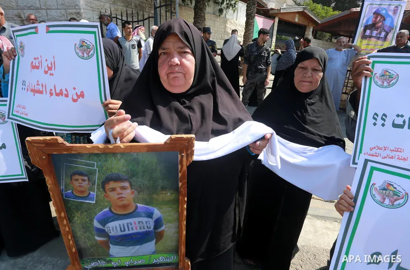 Palestinian families of martyrs take part a protest to demand their rights, in front of the headquarters of the Council of Ministers in Gaza city, on July 28, 2015. Photo by Mohammed Asad