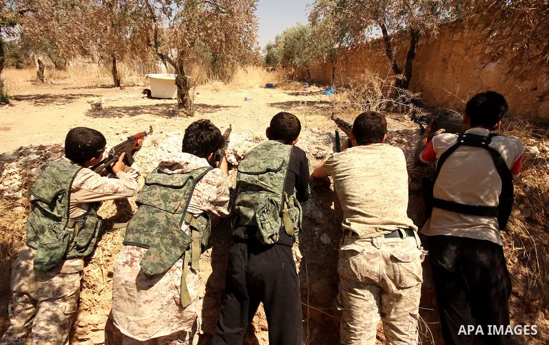 Fighters from the Free Syrian Army take position following clashes with the pro-regime forces, in Aziza village in the northern Syrian city of Aleppo, on July 28, 2015. Photo by Ameer al-Halbi