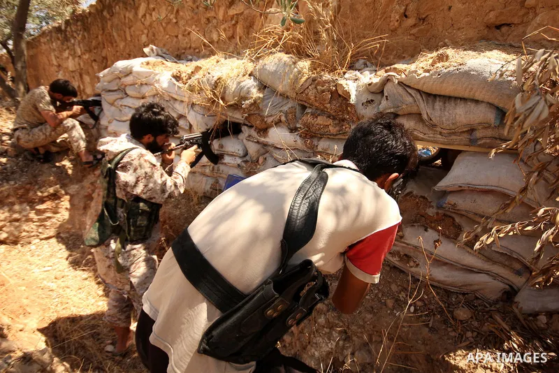 Fighters from the Free Syrian Army take position following clashes with the pro-regime forces, in Aziza village in the northern Syrian city of Aleppo, on July 28, 2015. Photo by Ameer al-Halbi