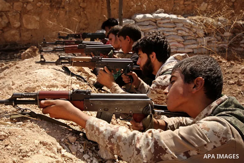 Fighters from the Free Syrian Army take position following clashes with the pro-regime forces, in Aziza village in the northern Syrian city of Aleppo, on July 28, 2015. Photo by Ameer al-Halbi