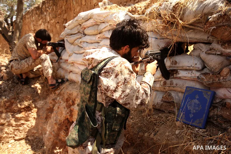 Fighters from the Free Syrian Army take position following clashes with the pro-regime forces, in Aziza village in the northern Syrian city of Aleppo, on July 28, 2015. Photo by Ameer al-Halbi