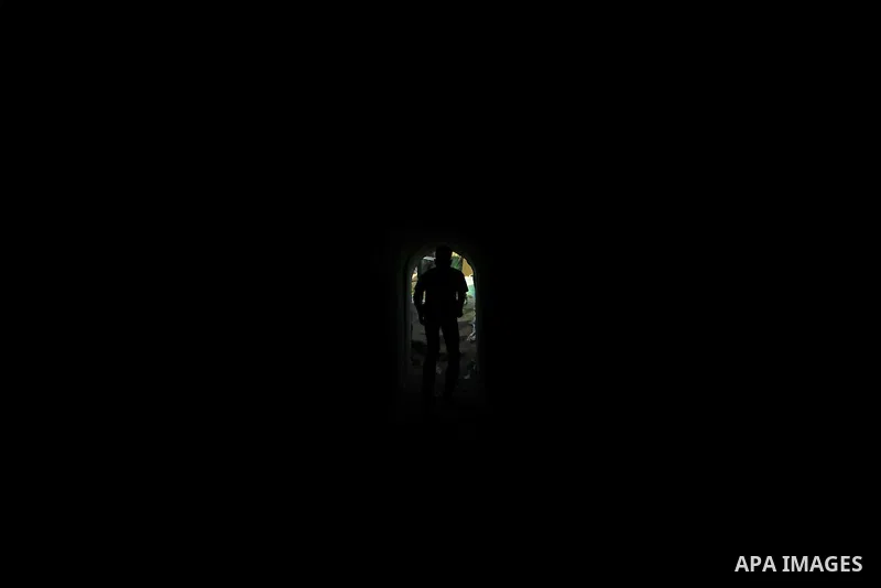 A Palestinian man walks in a military tunnel during a weapons exhibition in a military-style camp organized by the Hamas movement in Gaza City on July 28, 2015. Hamas's armed wing organized "Liberation Youths Camps" for...
