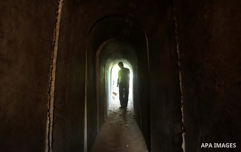 A Palestinian man walks in a military tunnel during a weapons exhibition in a military-style camp organized by the Hamas movement in Gaza City on July 28, 2015. Hamas's armed wing organized "Liberation Youths Camps" for...