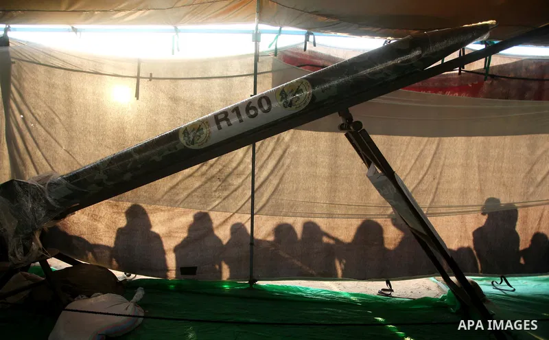 Palestinians watch weapons that used during the Israeli 50-day war on Gaza Strip last summer, during a weapons exhibition in a military-style camp organized by the Hamas movement in Gaza City on July 28, 2015. Hamas's ar...
