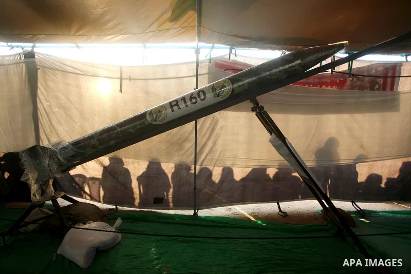 Palestinians watch weapons that used during the Israeli 50-day war on Gaza Strip last summer, during a weapons exhibition in a military-style camp organized by the Hamas movement in Gaza City on July 28, 2015. Hamas's ar...