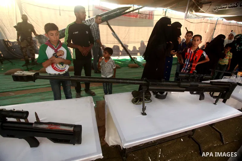 Palestinians watch weapons that used during the Israeli 50-day war on Gaza Strip last summer, during a weapons exhibition in a military-style camp organized by the Hamas movement in Gaza City on July 28, 2015. Hamas's ar...