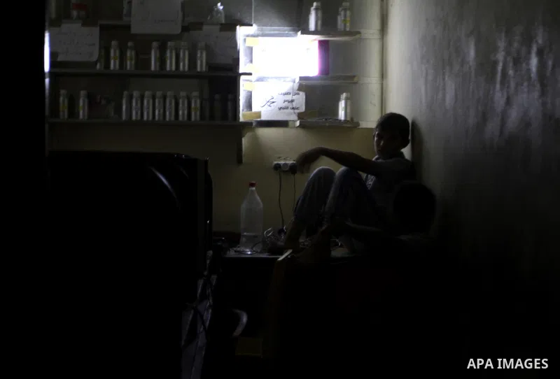 Palestinian family use a candle light during a power cut in Rafah in the southern Gaza Strip, on July 28, 2015. Independent Commission for Human Rights warned Saturday of the aggravated humanitarian situation in Gaza due...