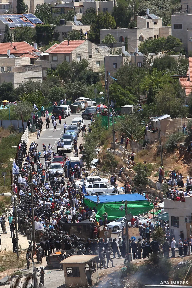Israeli settlers watch the demolition of a building, in the West Bank Jewish settlement of Beit El near Ramallah July 29, 2015. Israel gave final approval on Wednesday for plans to build 300 new homes in the Jewish settl...