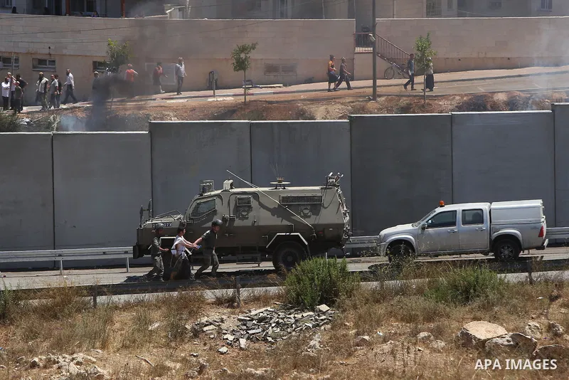 Israeli settlers watch the demolition of a building, in the West Bank Jewish settlement of Beit El near Ramallah July 29, 2015. Israel gave final approval on Wednesday for plans to build 300 new homes in the Jewish settl...