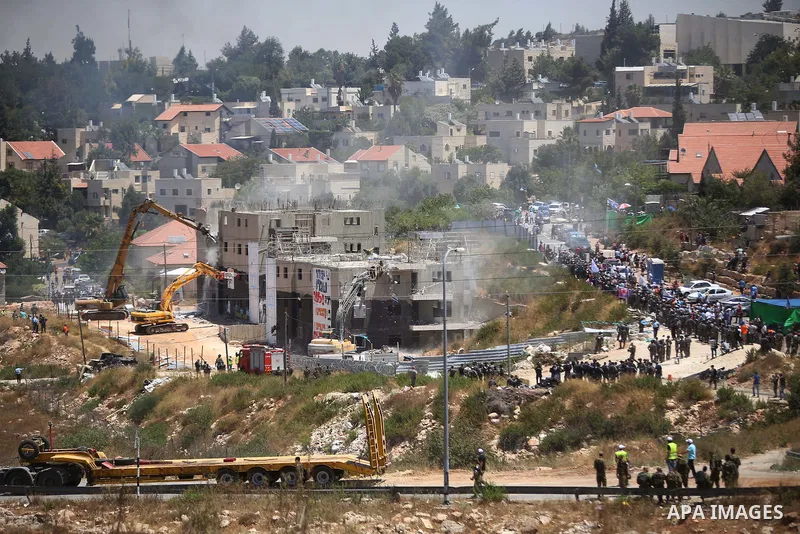 Israeli heavy machinery demolish vacant apartment blocs by order of Israel's high court, in the West Bank Jewish settlement of Beit El near Ramallah July 29, 2015. Israel gave final approval on Wednesday for plans to bui...