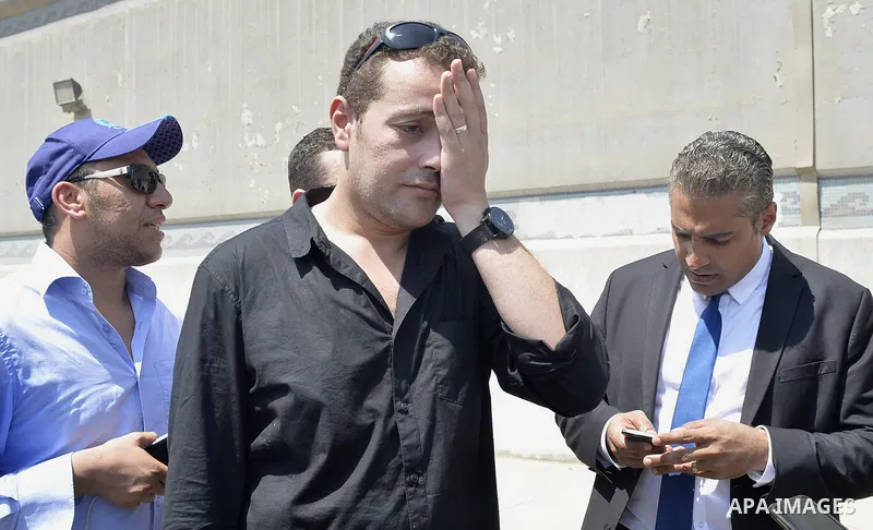 Egyptian Al-Jazeera English journalist Baher Mohammed, and Al-Jazeera English journalist Mohammed Fahmy, speak outside Tora prison, in Cairo, Egypt, Thursday, July 30, 2015. Egyptian judicial officials say a Cairo court...
