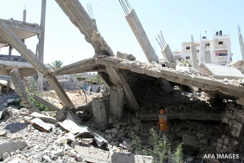 A Palestinian girl plays on the rubble of a house, which was destroyed during the 50-day war between Israel and Hamas militants in the summer of 2014, in Rafah in the southern Gaza Strip on July 29, 2015. An analysis of...