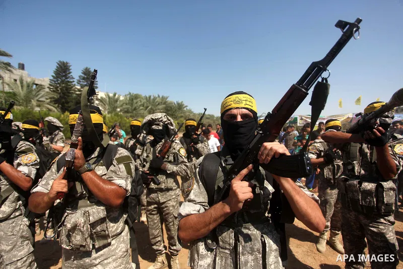Palestinian militants of al-Aqsa brigades, the armed wing of Fatah movement, celebrate the release of prisoner Mahmoud Abu Amra from an Israeli jail, in Deir al-Balah in the central Gaza Strip, July 30, 2015. Abu Amra se...