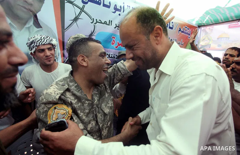 Freed Palestinian prisoner Mahmoud Abu Amra is welcomed by a relative upon his release from an Israeli jail, at his home in Deir al-Balah in the central Gaza Strip, July 30, 2015. Abu Amra served 12 years in the Israeli...