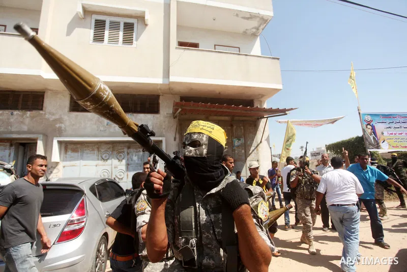 Palestinian militants of al-Aqsa brigades, the armed wing of Fatah movement, celebrate the release of prisoner Mahmoud Abu Amra from an Israeli jail, in Deir al-Balah in the central Gaza Strip, July 30, 2015. Abu Amra se...
