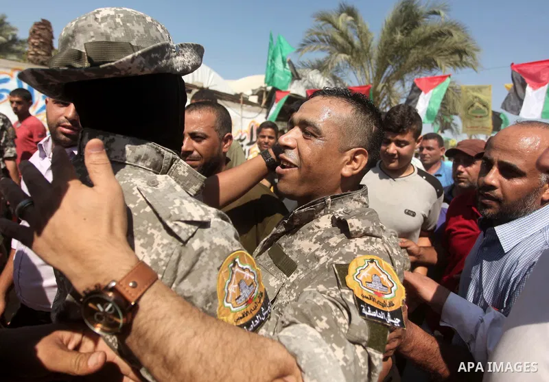 Freed Palestinian prisoner Mahmoud Abu Amra is welcomed by a member of al-Aqsa brigades, the armed wing of Fatah movement, upon his release from an Israeli jail, in Deir al-Balah in the central Gaza Strip, July 30, 2015....