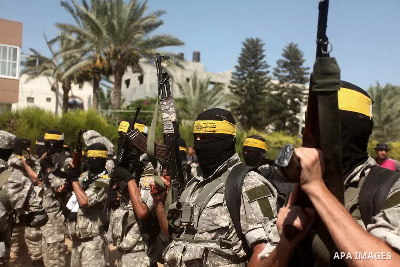 Palestinian militants of al-Aqsa brigades, the armed wing of Fatah movement, celebrate the release of prisoner Mahmoud Abu Amra from an Israeli jail, in Deir al-Balah in the central Gaza Strip, July 30, 2015. Abu Amra se...