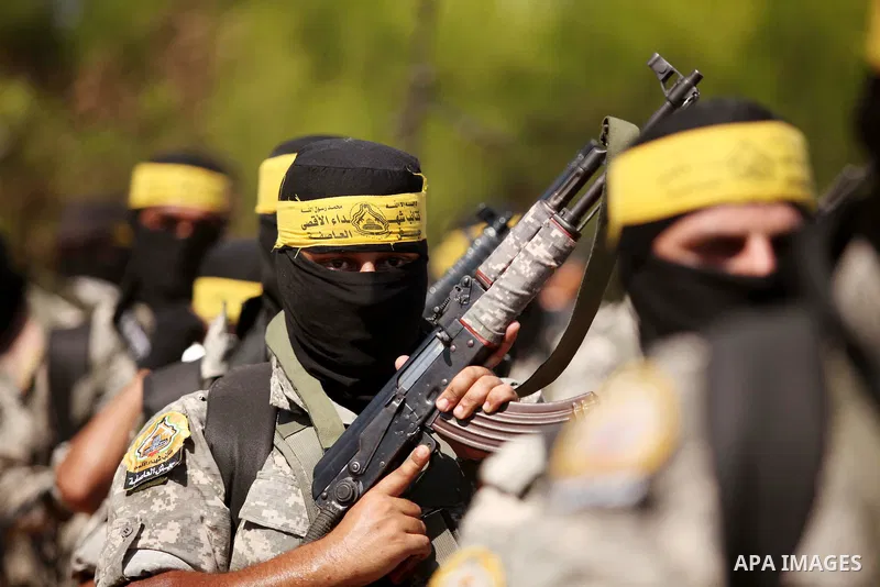 Palestinian militants of al-Aqsa brigades, the armed wing of Fatah movement, celebrate the release of prisoner Mahmoud Abu Amra from an Israeli jail, in Deir al-Balah in the central Gaza Strip, July 30, 2015. Abu Amra se...