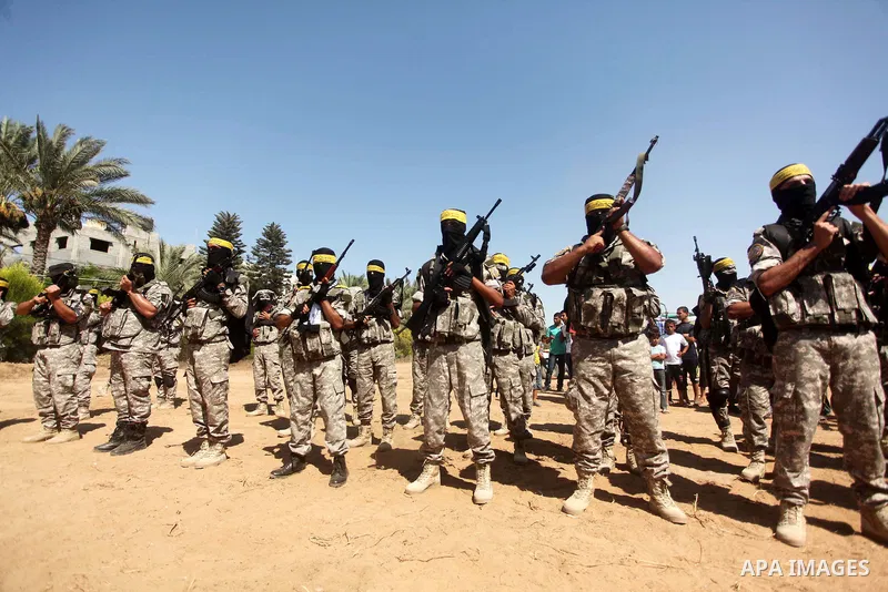 Palestinian militants of al-Aqsa brigades, the armed wing of Fatah movement, celebrate the release of prisoner Mahmoud Abu Amra from an Israeli jail, in Deir al-Balah in the central Gaza Strip, July 30, 2015. Abu Amra se...